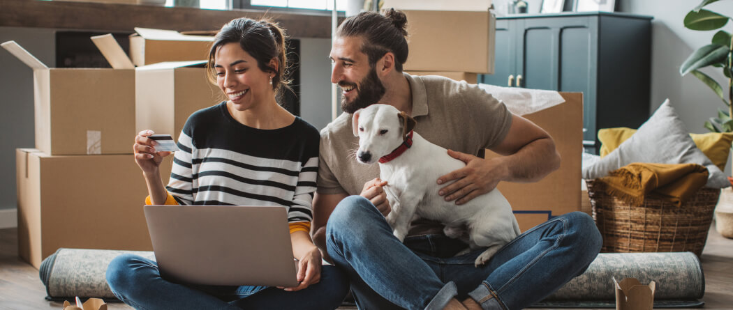 couple with dog and moving boxes