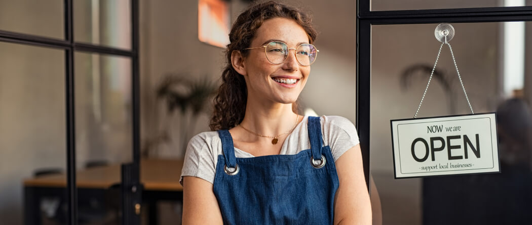 woman next to open sign